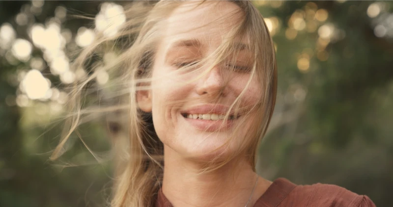 Client smiling outdoors after a guided cannabis psychedelic therapy session