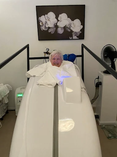 Practitioner preparing an ozone steam sauna session